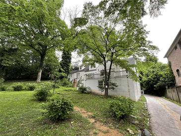 Charming two-story home with brick and white painted siding and landscaped yard at 55 Beverly Ne Rd, Atlanta, GA 30309