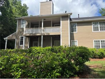 Two-story home featuring siding, a balcony, and a well-manicured lawn at 6449 Pinebark Way, Morrow, GA 30260