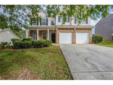 Charming two-story home with a brick facade, attached two-car garage, and well-maintained front yard at 8826 Lakecrest Way, Union City, GA 30291