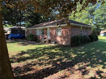 Charming, single-story brick home with mature landscaping and ample natural light at 1215 Sheppard Pl, Stone Mountain, GA 30083