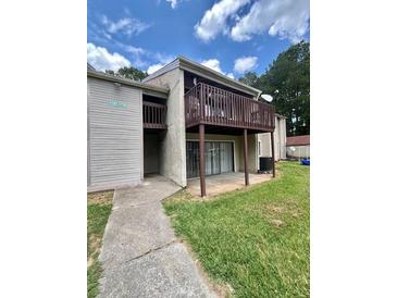 Exterior of building with a brown balcony, sliding glass doors and grassy lawn at 3575 Oakvale Rd # 1103, Decatur, GA 30034