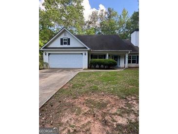 Charming single-story home with a well-maintained lawn, attached garage, and inviting front entrance at 5028 Highway 81, Mcdonough, GA 30252
