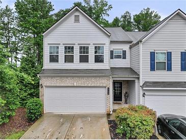 Charming two-story townhome featuring a two-car garage and well-maintained landscaping at 218 Piedmont Cir, Canton, GA 30114