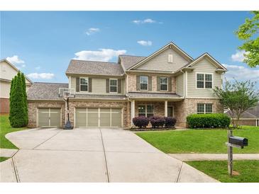 Attractive two-story home with a three-car garage, well-manicured lawn, and a basketball hoop in the driveway at 3700 Terrasol Sw Trl, Lilburn, GA 30047