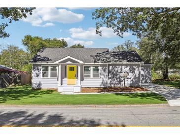 Charming single-story home with yellow front door and well-manicured lawn at 7540 Conyers St, Lithonia, GA 30058