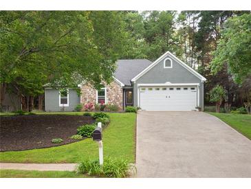 Charming home featuring a combination of stone and siding, complemented by a two-car garage and a well-maintained front yard at 1605 Barrier Rd, Marietta, GA 30066