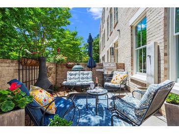 Inviting outdoor patio with cozy seating, a grill, and stylish decor, perfect for relaxation and entertaining guests at 3408 Landen Pine Ne Ct, Atlanta, GA 30305