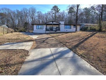 Charming single-story home featuring a well-manicured front yard and a concrete driveway at 52 Buena Vista Se Cir, Cartersville, GA 30121