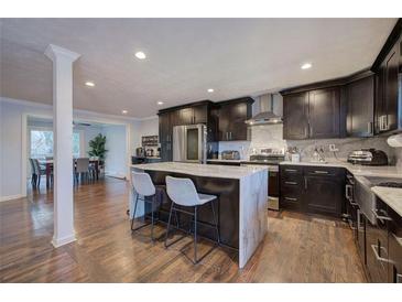 Open kitchen featuring an island with marble countertop and seating for two at 52 Buena Vista Se Cir, Cartersville, GA 30121