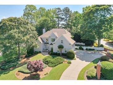 Stately two-story home with a lush front yard, elegant landscaping, and a circular driveway at 2250 Edgemere Lake Cir, Marietta, GA 30062
