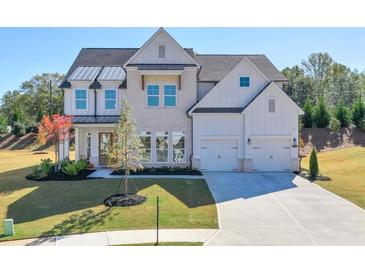 Beautiful two-story home with a two car garage, manicured lawn, and lovely landscaping at 3440 Carswell Bnd, Cumming, GA 30028