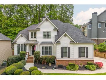 Charming two-story home with brick accents, lush landscaping, and a welcoming entrance at 690 Sienna Dr, Cumming, GA 30040