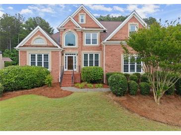 Beautiful brick two-story home with manicured lawn and mature landscaping at 1721 Mulberry Lake Dr, Dacula, GA 30019