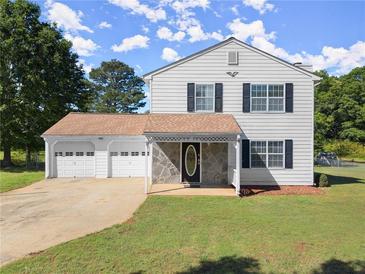 Charming two-story home featuring a spacious three-car garage and welcoming stone-accented entryway at 282 Oak Rdg, Auburn, GA 30011
