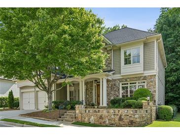 Charming two-story home featuring stone accents, a welcoming front porch, and a well-manicured lawn at 3687 Canyon Ridge Ne Ct, Brookhaven, GA 30319
