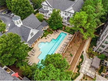 Aerial view of the community pool surrounded by lush greenery and lounge chairs at 951 Glenwood Se Ave # 1805, Atlanta, GA 30316