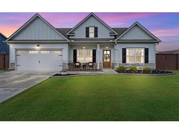 Charming one-story home with a manicured lawn, two-car garage and inviting front porch, showcasing curb appeal at 39 Summer Nw Pl, Cartersville, GA 30121
