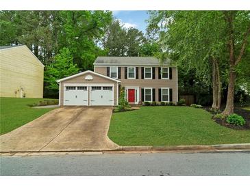 Charming two-story home with a well-manicured front yard and an attached two car garage at 2640 Garland Way, Duluth, GA 30096