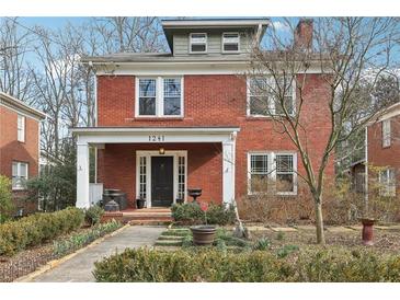 Charming two-story red brick home with inviting front porch and professionally landscaped front yard at 1241 Briarcliff Ne Rd, Atlanta, GA 30306