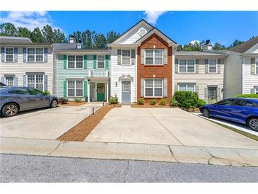 Charming townhome with a combination of brick and siding exterior and individual driveways at 4100 Howell Park Rd, Duluth, GA 30096
