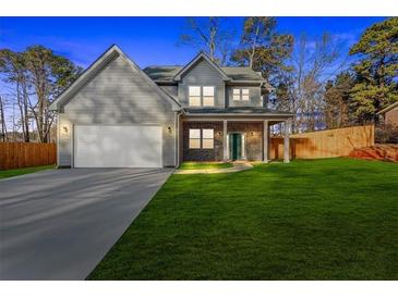 Charming two-story home featuring a spacious two-car garage and a welcoming covered front porch at 4806 Forest Trl, Douglasville, GA 30135