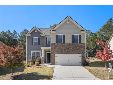 Two-story home featuring mixed material facade of stone, board and batten, and traditional siding at 3013 Nicholas Dr, Villa Rica, GA 30180