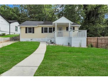 Charming home features a welcoming front porch and a well-manicured lawn at 2084 Bethel Nw Dr, Atlanta, GA 30314