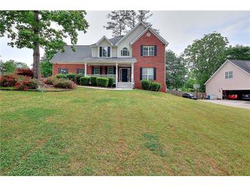 Charming two-story brick home with a well-manicured lawn and inviting front porch at 931 Bonaventure Way, Lawrenceville, GA 30044