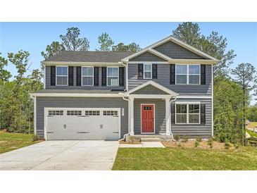 Charming two-story home with gray siding, black shutters, and a two-car garage at 8491 Limerick Ln, Winston, GA 30187