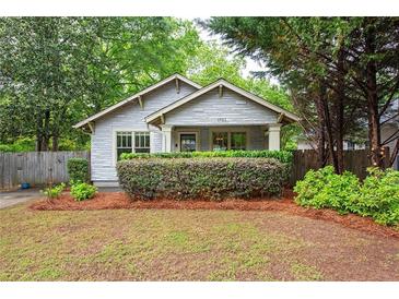 Charming bungalow featuring manicured landscaping and a welcoming front porch at 1761 Flat Shoals Se Rd, Atlanta, GA 30316