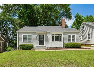 Charming single-story home with a grey exterior, brick chimney, and well-manicured lawn at 1100 Faith Se Ave, Atlanta, GA 30316