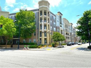 Modern apartment building with colorful exterior, manicured landscaping, and visible scooter rentals at 390 17Th Nw St # 6001, Atlanta, GA 30363