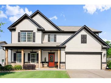 Charming two-story home featuring a welcoming front porch and a well-maintained lawn at 6235 Crescent Landing Dr, Cumming, GA 30028