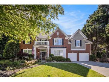 Beautiful two-story brick home featuring an attached two-car garage and a well-manicured lawn at 5004 Lake Mist Se Dr, Mableton, GA 30126