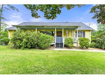 Charming single-story home with a welcoming front porch and lush green lawn at 4720 Bill Cheek Rd, Auburn, GA 30011