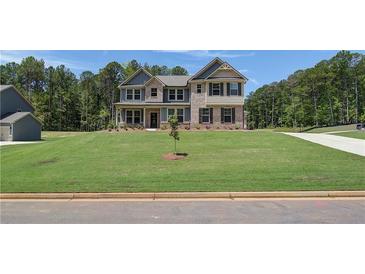 Beautiful two-story brick home with well-manicured lawn and a welcoming front entrance at 68 Homesite Cooper W Cv, Fayetteville, GA 30214