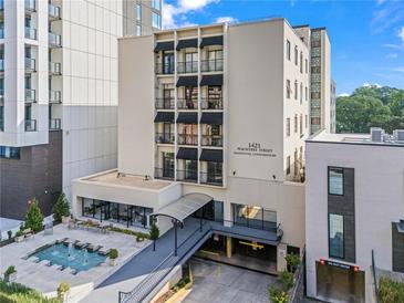 Beautiful condo building at 1421 Peachtree Street, featuring a fountain, covered entry, and secure parking at 1421 Peachtree Ne St # 214, Atlanta, GA 30309