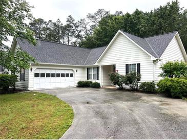 Charming single-story home with white siding, black shutters, and a two-car garage at 1255 Summit Point Ln, Snellville, GA 30078