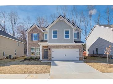 Charming two-story home featuring a brick facade and a two-car garage, perfect for suburban living at 327 Tulip Dr, Covington, GA 30016