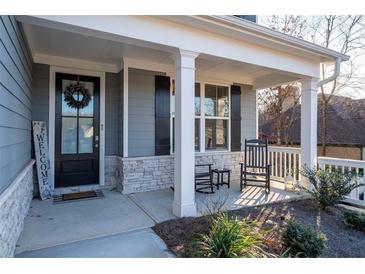 Charming front porch featuring rocking chairs and a welcoming entrance with a wreath on the door at 15 Parkside Vw, Cartersville, GA 30121
