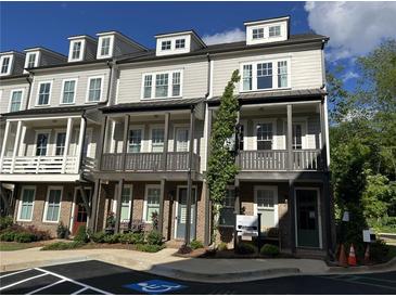 Exterior view of modern townhomes featuring individual balconies and covered front entries for stylish curb appeal at 4200 Legacy Ln # 22, Acworth, GA 30101
