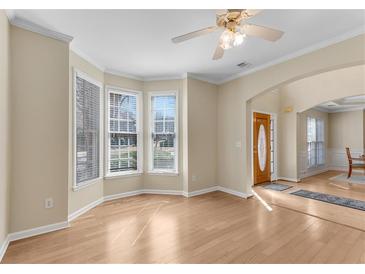 Bright living room featuring beautiful hardwood floors, large windows, and neutral wall colors at 1107 Carroll Ct, Norcross, GA 30071