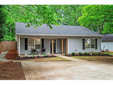Charming single-story home with gray siding, black shutters, and a well-manicured front yard at 2565 Bates Se St, Smyrna, GA 30080
