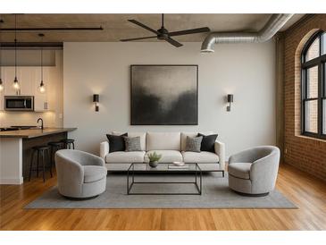 Bright living room with modern furnishings, an open ceiling, and ductwork, and hardwood floors at 3235 Roswell Ne Rd # 521, Atlanta, GA 30305
