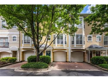 Inviting townhome exterior with attached garages and well-maintained landscaping offering curb appeal at 375 Highland Ne Ave # 913, Atlanta, GA 30312