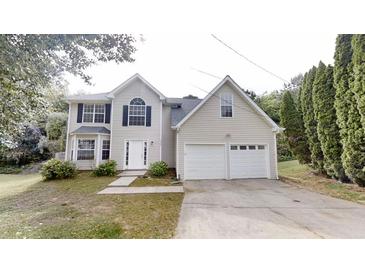 Charming two-story home with a double garage and well-maintained lawn at 5246 Salem Springs Pl, Lithonia, GA 30038