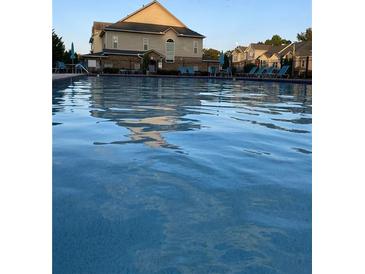 Community pool with lounge chairs, perfect for relaxing on a hot summer day at 106 Trailside Way, Hiram, GA 30141