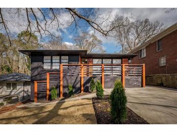 Modern, two-story home with a black brick facade, and a well-manicured landscaped front yard at 1605 Ezra Church Nw Dr, Atlanta, GA 30314