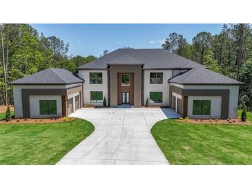 Stunning two-story home featuring a symmetrical design and large front yard with a long private driveway at 2843 N North Bogan Rd, Buford, GA 30519