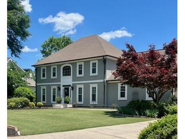 Charming two-story home with a well-manicured lawn and mature landscaping in a desirable neighborhood at 435 Chantenay Pl, Alpharetta, GA 30022